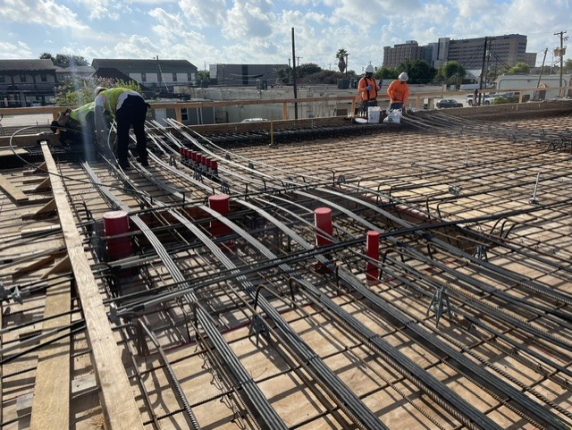 Rebar grid and post-tension cables for a commercial deck pour